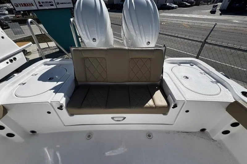  Yacht Photos Pics 2026 Blazer Bay Makaira 2800 boat interior with cushioned seating and dual engines.