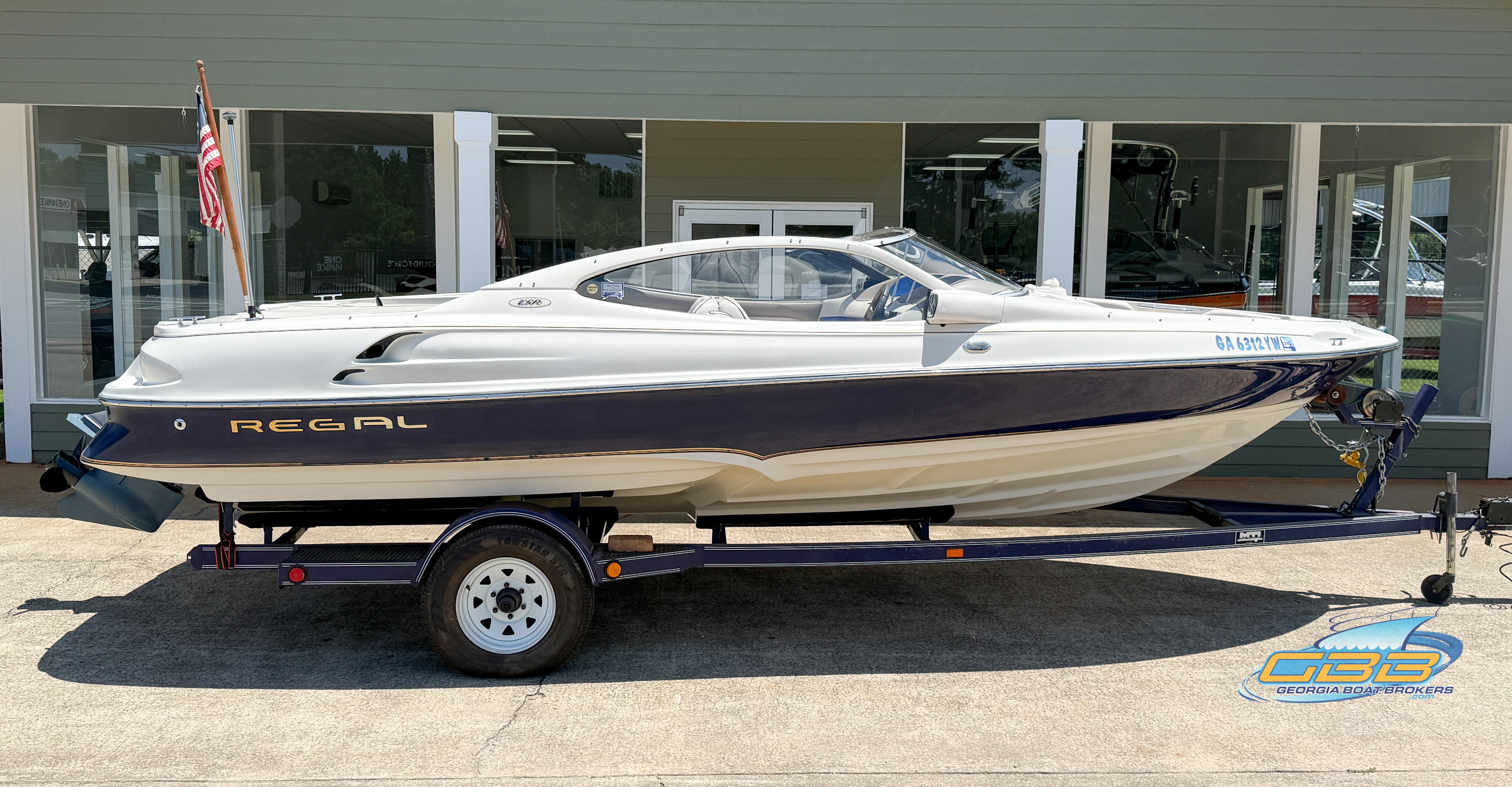 1998 Regal 2100 LSR boat on trailer, displayed outdoors, side view.