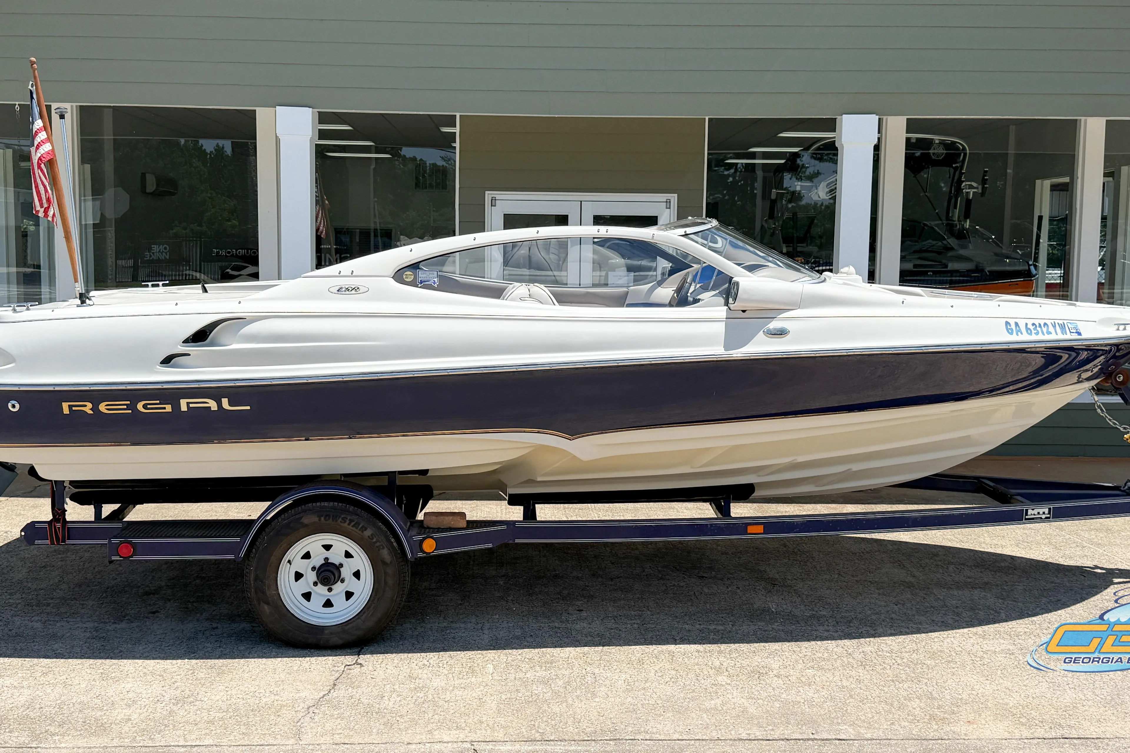 1998 Regal 2100 LSR boat on trailer, displayed outdoors, side view.