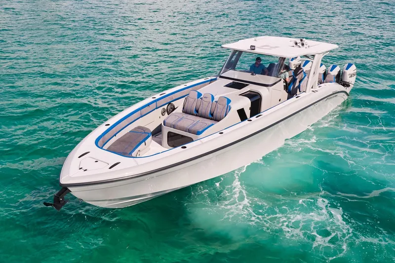  Yacht Photos Pics 2023 Midnight Express 43 Solstice boat cruising on clear turquoise water.