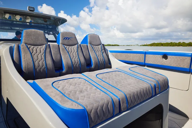  Yacht Photos Pics Luxurious seating on 2023 Midnight Express 43 Solstice boat, featuring blue and gray upholstery.