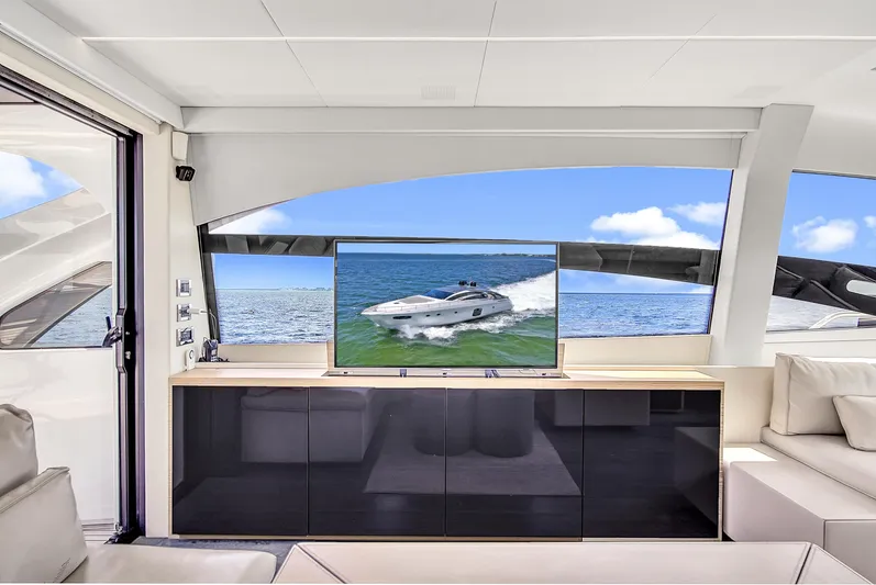 Pershing 70 White Yacht Photos Pics Luxurious interior of 2016 Pershing 70 yacht with ocean view and modern TV setup.