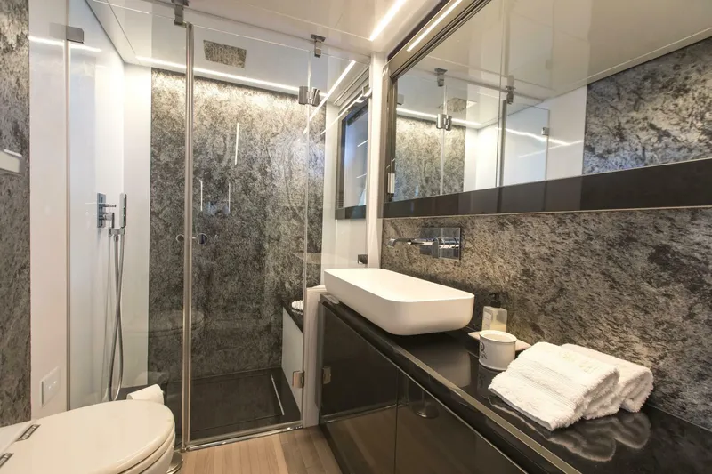 Pershing 70 White Yacht Photos Pics Luxurious bathroom in a 2016 Pershing 70 yacht, featuring modern fixtures and elegant design.