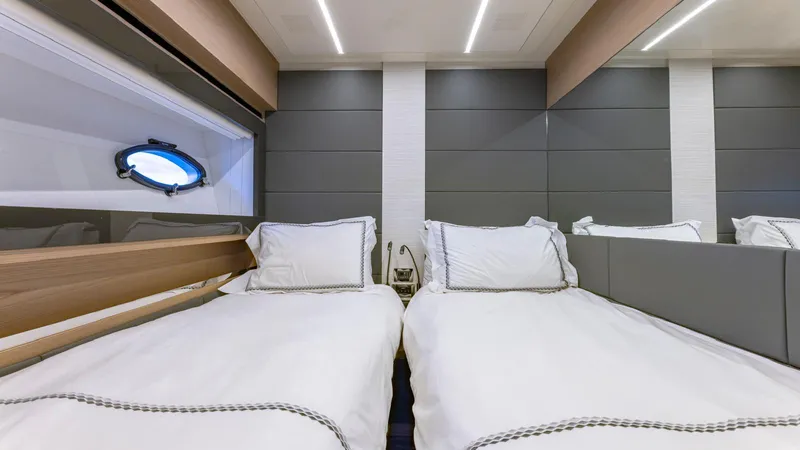 Pershing 70 White Yacht Photos Pics Luxurious twin cabin interior on a 2016 Pershing 70 yacht, featuring modern design and comfort.