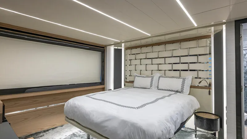 Pershing 70 White Yacht Photos Pics Luxurious bedroom interior on 2016 Pershing 70 yacht, featuring modern design and ambient lighting.