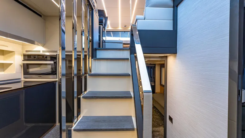 Pershing 70 White Yacht Photos Pics Interior of 2016 Pershing 70 yacht with modern staircase and sleek design.