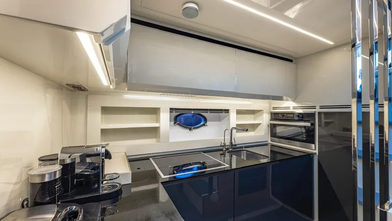 Pershing 70 White Yacht Photos Pics Modern kitchen interior on a 2016 Pershing 70 yacht, featuring sleek design and appliances.