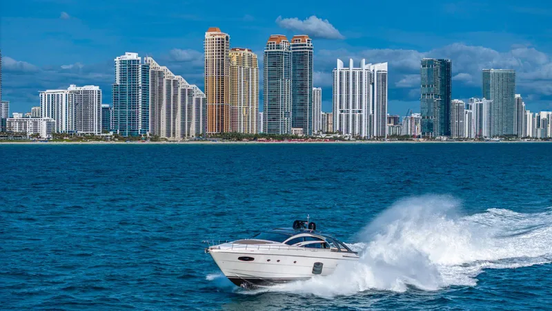Pershing 70 White Yacht Photos Pics 2016 Pershing 70 yacht cruising near a city skyline with tall buildings.