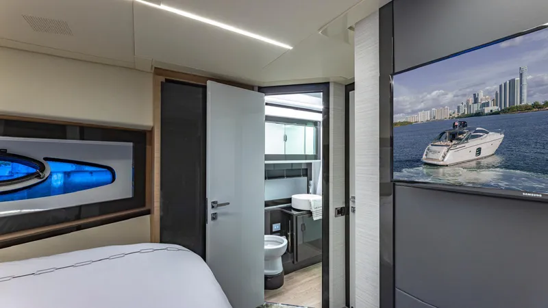 Pershing 70 White Yacht Photos Pics Luxurious interior of 2016 Pershing 70 yacht with modern bathroom and wall-mounted TV.