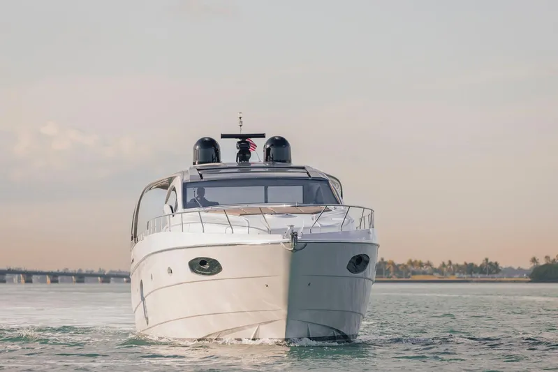 Pershing 70 White Yacht Photos Pics 2016 Pershing 70 yacht cruising on calm waters at sunset.
