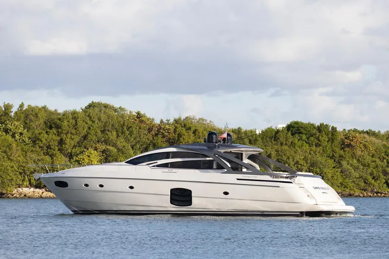 Pershing 70 White Yacht Photos Pics 2016 Pershing 70 yacht cruising on calm waters near lush greenery.