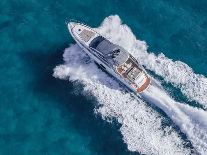 Pershing 70 White Yacht Photos Pics Luxury Pershing 70 yacht cruising on clear blue waters, aerial view, 2016 model.