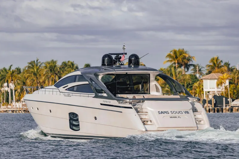 Pershing 70 White Yacht Photos Pics 2016 Pershing 70 yacht cruising near tropical shoreline with palm trees.