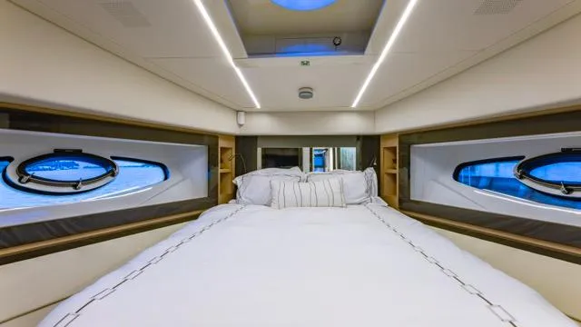 Pershing 70 White Yacht Photos Pics Luxurious bedroom interior of 2016 Pershing 70 yacht with modern design and porthole windows.