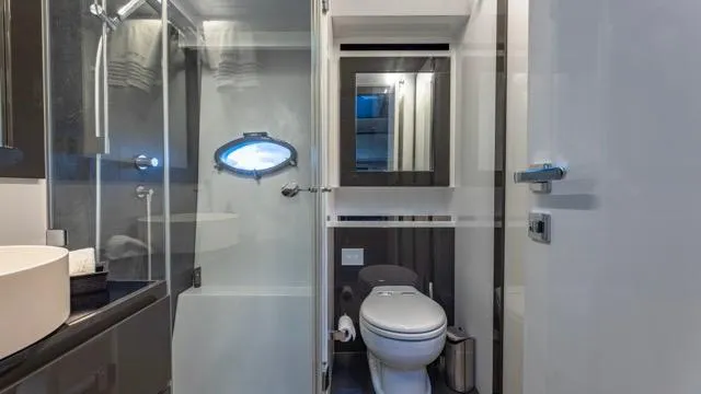 Pershing 70 White Yacht Photos Pics Luxurious bathroom interior of a 2016 Pershing 70 yacht, featuring modern fixtures and sleek design.