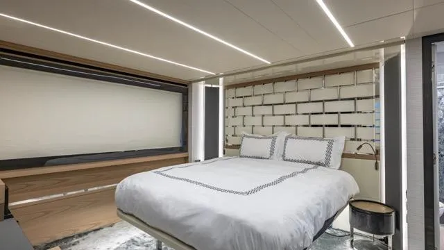 Pershing 70 White Yacht Photos Pics Luxurious bedroom interior on a 2016 Pershing 70 yacht, featuring modern design and ambient lighting.