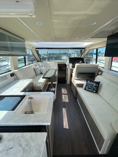  Yacht Photos Pics 2020 Regal 38 Grande Coupe interior with modern seating, kitchenette, and helm.