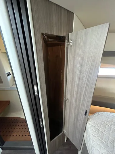  Yacht Photos Pics 2020 Regal 38 Grande Coupe interior with open wooden closet door.