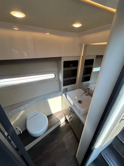  Yacht Photos Pics Modern bathroom interior of 2020 Regal 38 Grande Coupe yacht, featuring sleek fixtures and lighting.