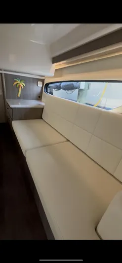  Yacht Photos Pics Interior of 2020 Regal 38 Grande Coupe with beige seating and palm tree decor.