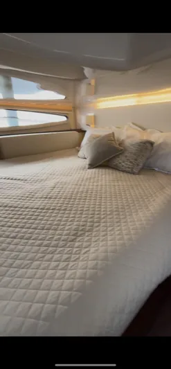  Yacht Photos Pics Luxurious bedroom interior of 2020 Regal 38 Grande Coupe yacht with elegant bedding.