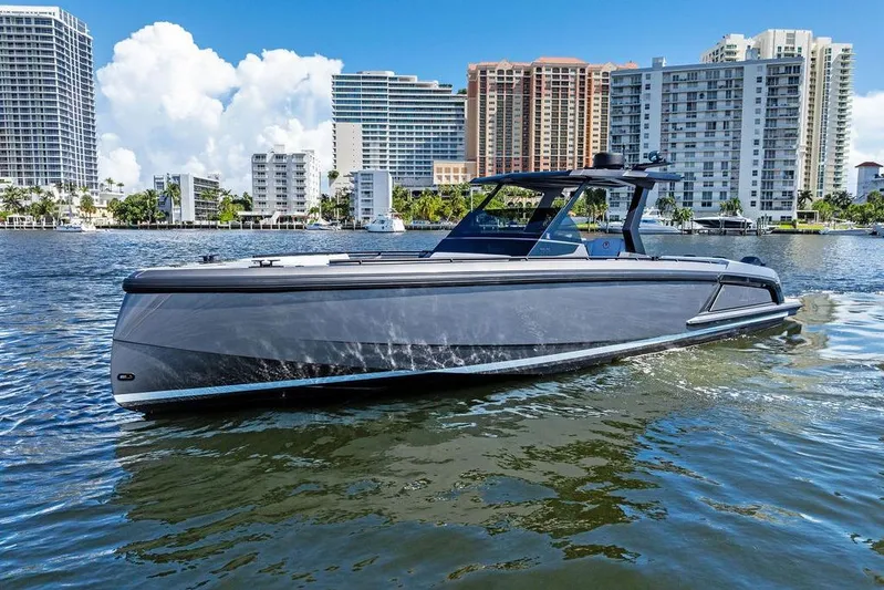 Not His Yacht Photos Pics 2024 Vanquish Yachts 40 cruising in urban waterfront setting with modern buildings.