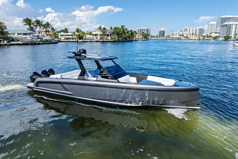 Not His Yacht Photos Pics 2024 Vanquish Yachts 40 cruising on a sunny day in a coastal city.