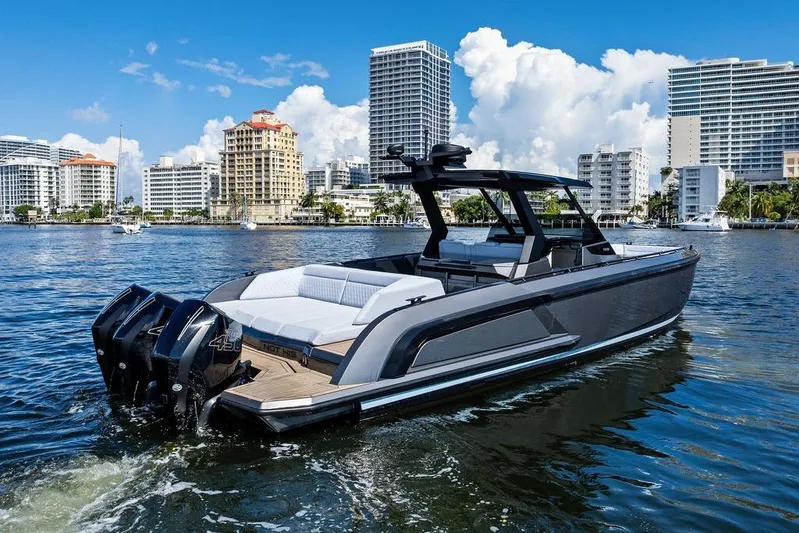 Not His Yacht Photos Pics 2024 Vanquish Yachts 40 on water, city skyline background, luxury motorboat.