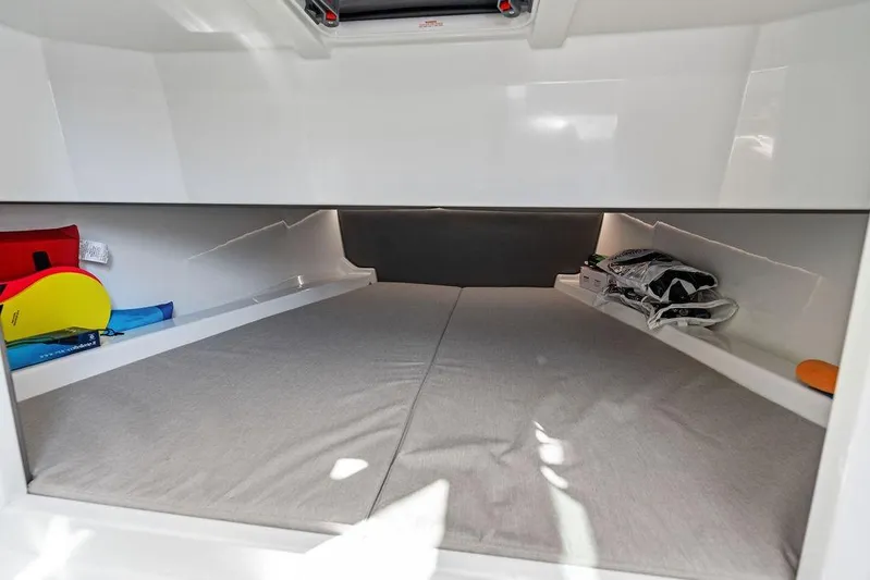 Not His Yacht Photos Pics 2024 Vanquish Yachts 40 interior cabin with storage and sleeping area.