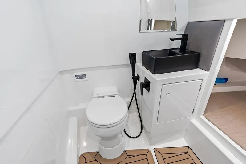 Not His Yacht Photos Pics Modern bathroom in 2024 Vanquish Yachts 40, featuring sleek fixtures and compact design.