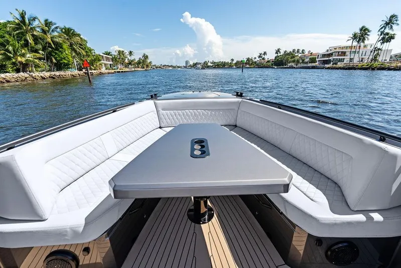 Not His Yacht Photos Pics Luxurious 2024 Vanquish Yachts 40 with elegant seating and scenic waterway view.