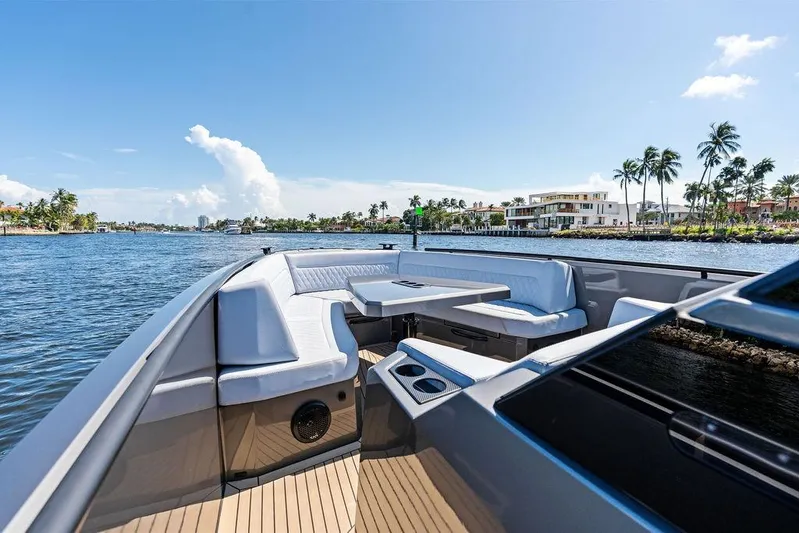 Not His Yacht Photos Pics 2024 Vanquish Yachts 40 on water, featuring luxurious seating and scenic coastal view.