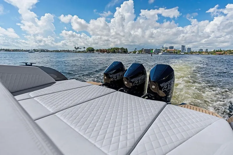 Not His Yacht Photos Pics 2024 Vanquish Yachts 40 with triple outboard engines cruising on a sunny day.