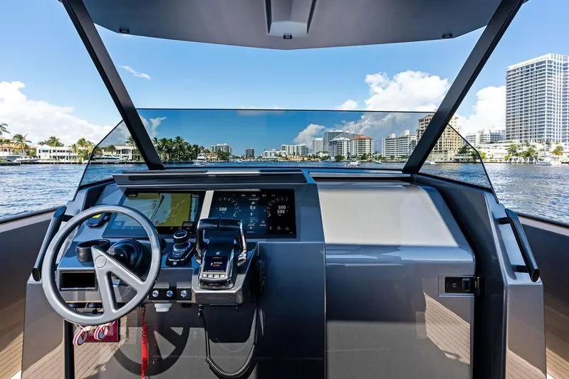 Not His Yacht Photos Pics 2024 Vanquish Yachts 40 helm with modern controls and city skyline view.