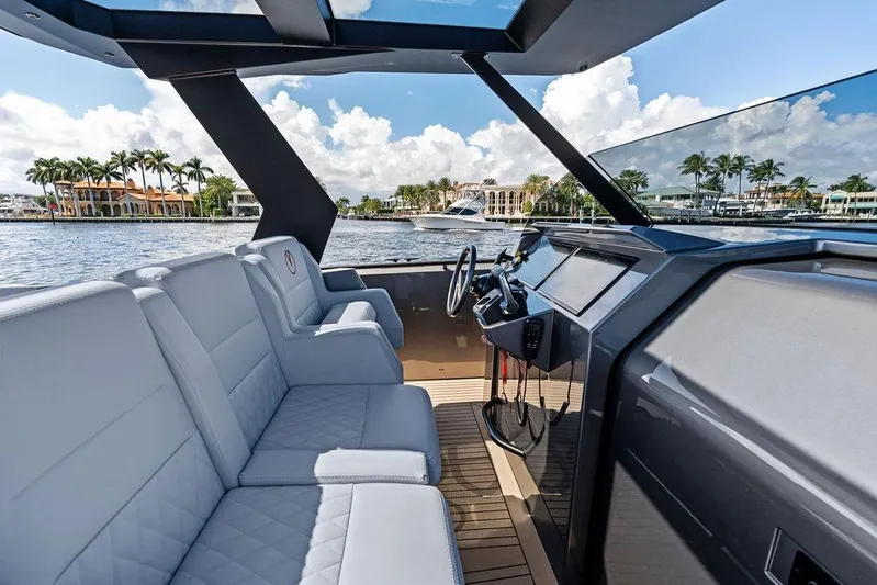 Not His Yacht Photos Pics 2024 Vanquish Yachts 40 interior with luxurious seating and modern dashboard on a sunny day.