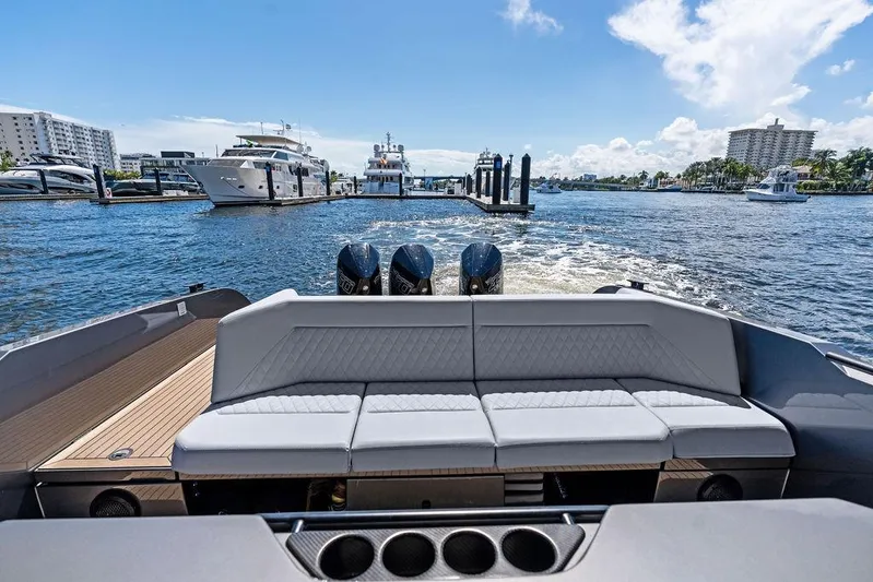 Not His Yacht Photos Pics 2024 Vanquish Yachts 40, luxury yacht interior with plush seating, docked in a sunny marina.