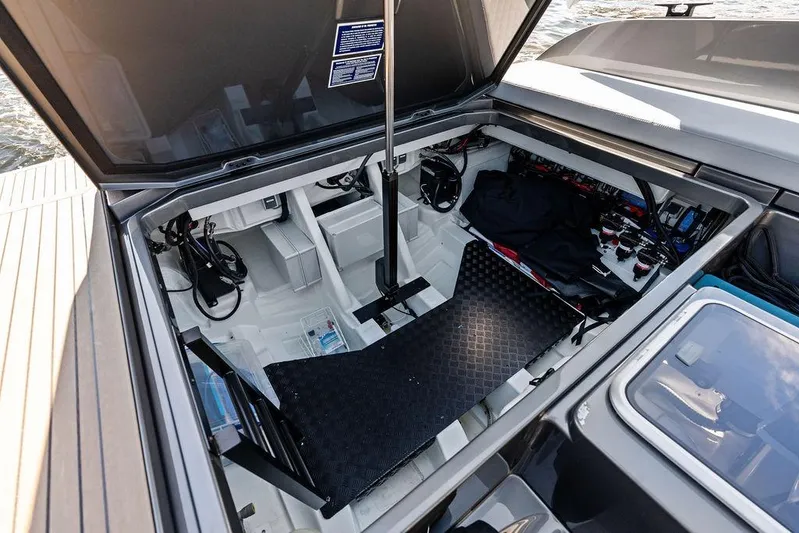 Not His Yacht Photos Pics Open engine compartment of 2024 Vanquish Yachts 40, showcasing internal components and storage.