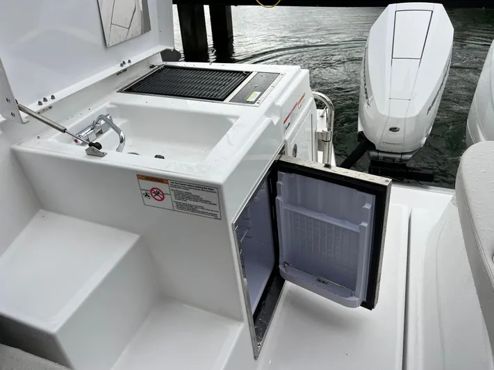  Yacht Photos Pics 2025 Beneteau Gran Turismo 36 yacht with outdoor sink, grill, and open mini fridge.