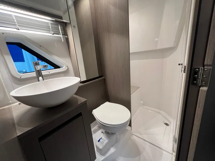  Yacht Photos Pics Modern bathroom in 2025 Beneteau Gran Turismo 36 yacht with sink, toilet, and shower.