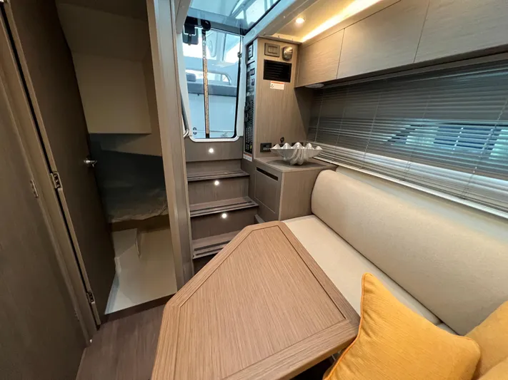  Yacht Photos Pics Interior of 2025 Beneteau Gran Turismo 36 yacht, featuring modern seating and wooden table.