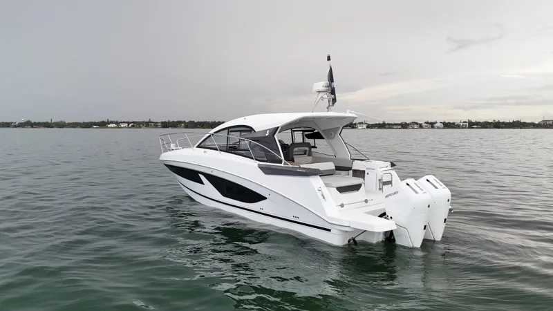  Yacht Photos Pics 2025 Beneteau Gran Turismo 36 yacht on calm water, showcasing sleek design and twin outboard engines.