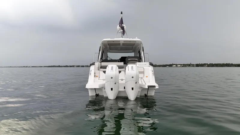  Yacht Photos Pics 2025 Beneteau Gran Turismo 36 yacht on calm water, rear view with dual engines.