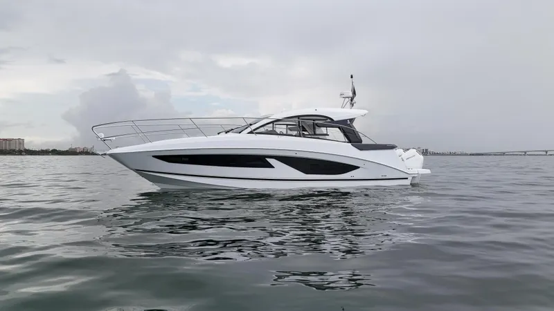  Yacht Photos Pics 2025 Beneteau Gran Turismo 36 yacht on calm water under cloudy sky.