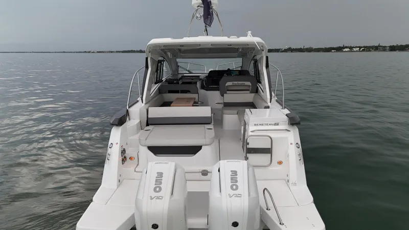  Yacht Photos Pics 2025 Beneteau Gran Turismo 36 yacht on calm water, rear view with twin Mercury engines.