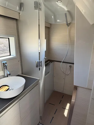  Yacht Photos Pics Modern bathroom interior in 2025 YOT 41 yacht, featuring sleek design and compact shower area.