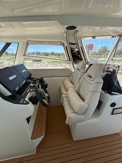  Yacht Photos Pics Interior of 2025 YOT 41 boat with modern helm and plush seating.