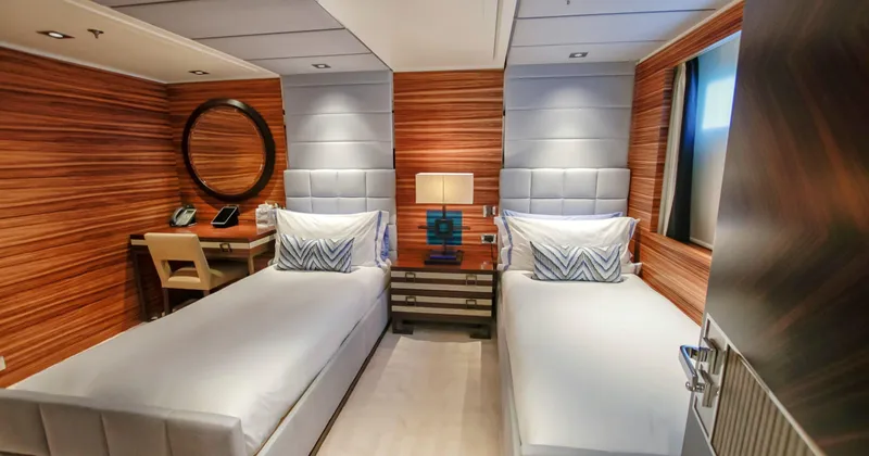 W Yacht Photos Pics Luxurious twin cabin interior on 2013 Feadship yacht, featuring wood paneling and modern decor.