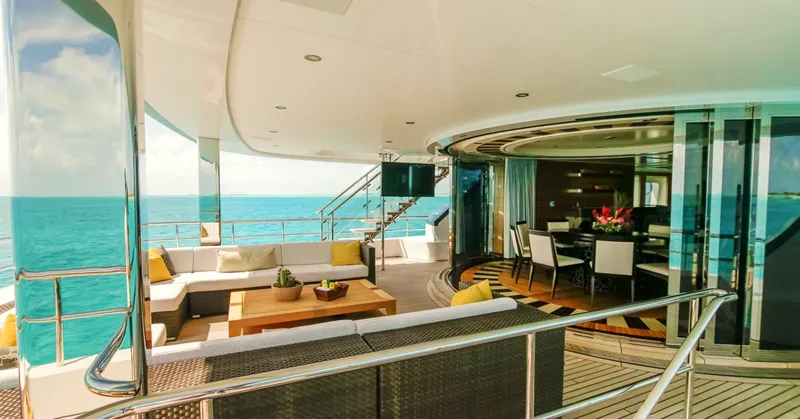 W Yacht Photos Pics Luxurious 2013 Feadship yacht interior with ocean view, featuring elegant seating and dining area.