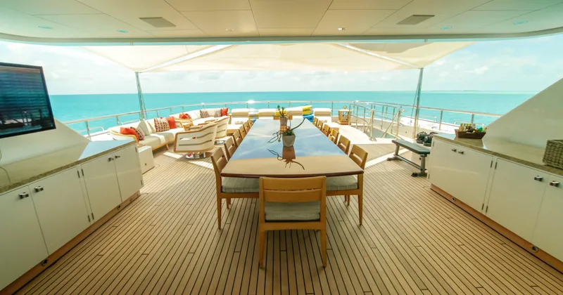 W Yacht Photos Pics Luxurious 2013 Feadship yacht deck with dining area, ocean view, and elegant seating.