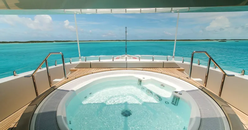 W Yacht Photos Pics Luxurious Feadship yacht deck with jacuzzi overlooking turquoise ocean, 2013 model.